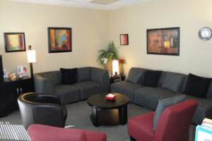 Anger Management Sherman Oaks Office meeting room, 2 grey sofas, black chair, round coffee table