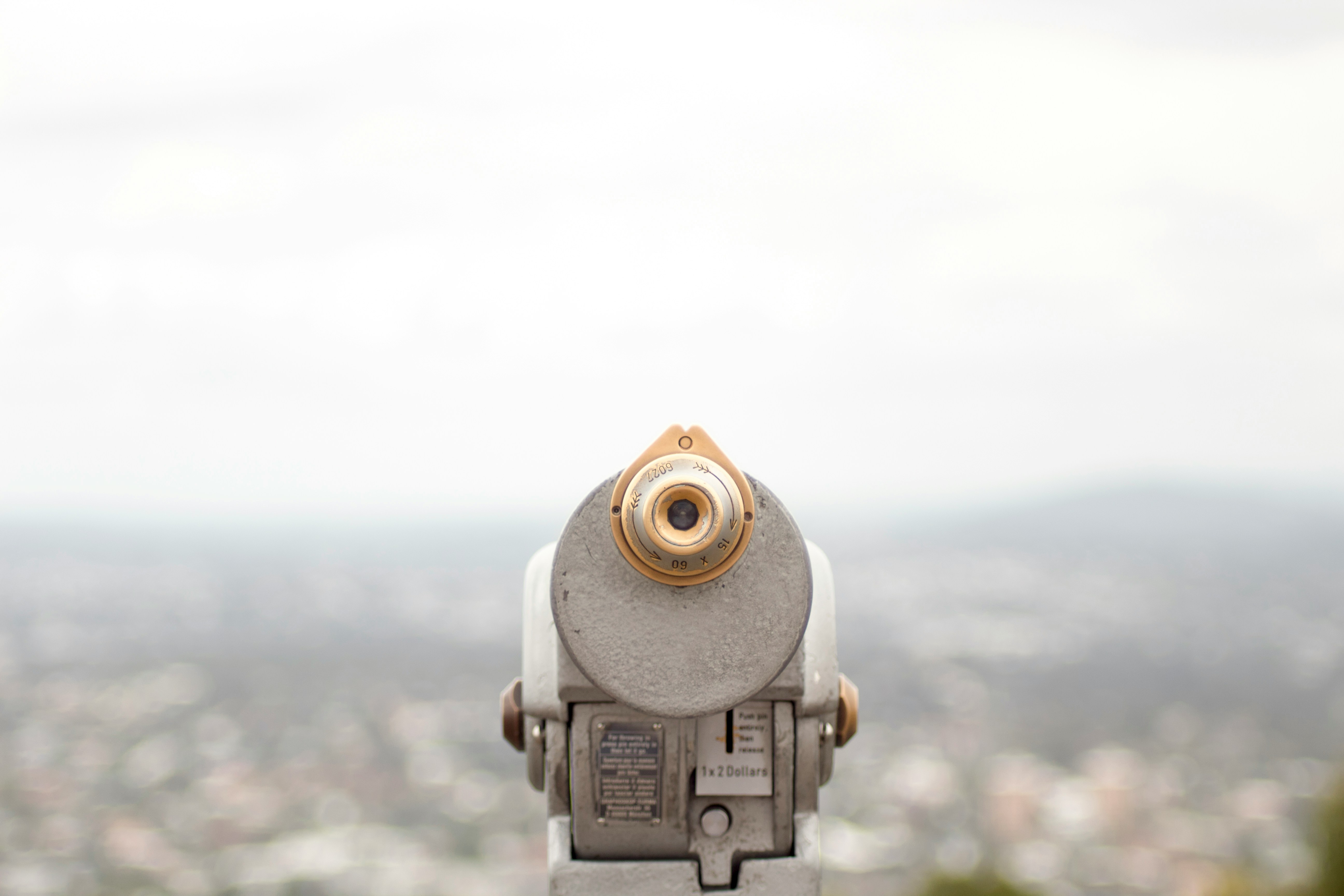 A white telescope facing the city