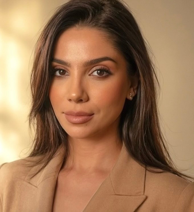 Sophie Grigoryan, AMFT, APCC. A woman with long brown hair and natural makeup is looking at the camera against a soft, neutral background.
