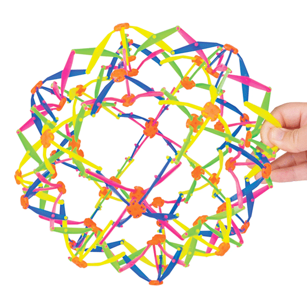 A hand is holding a colorful, expandable plastic sphere toy made of interlocking joints and flexible rods, shown partially expanded.